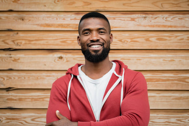 client pmm Headshot of a mid-adult man standing with his arms crossed and looking at the camera.